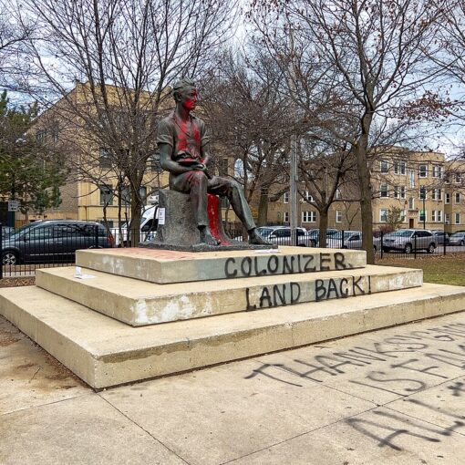 Statue of Abraham Lincoln with "Colonizer" and "Land Back" spray painted on pedastal as well as "Thanksgiving is Fake."